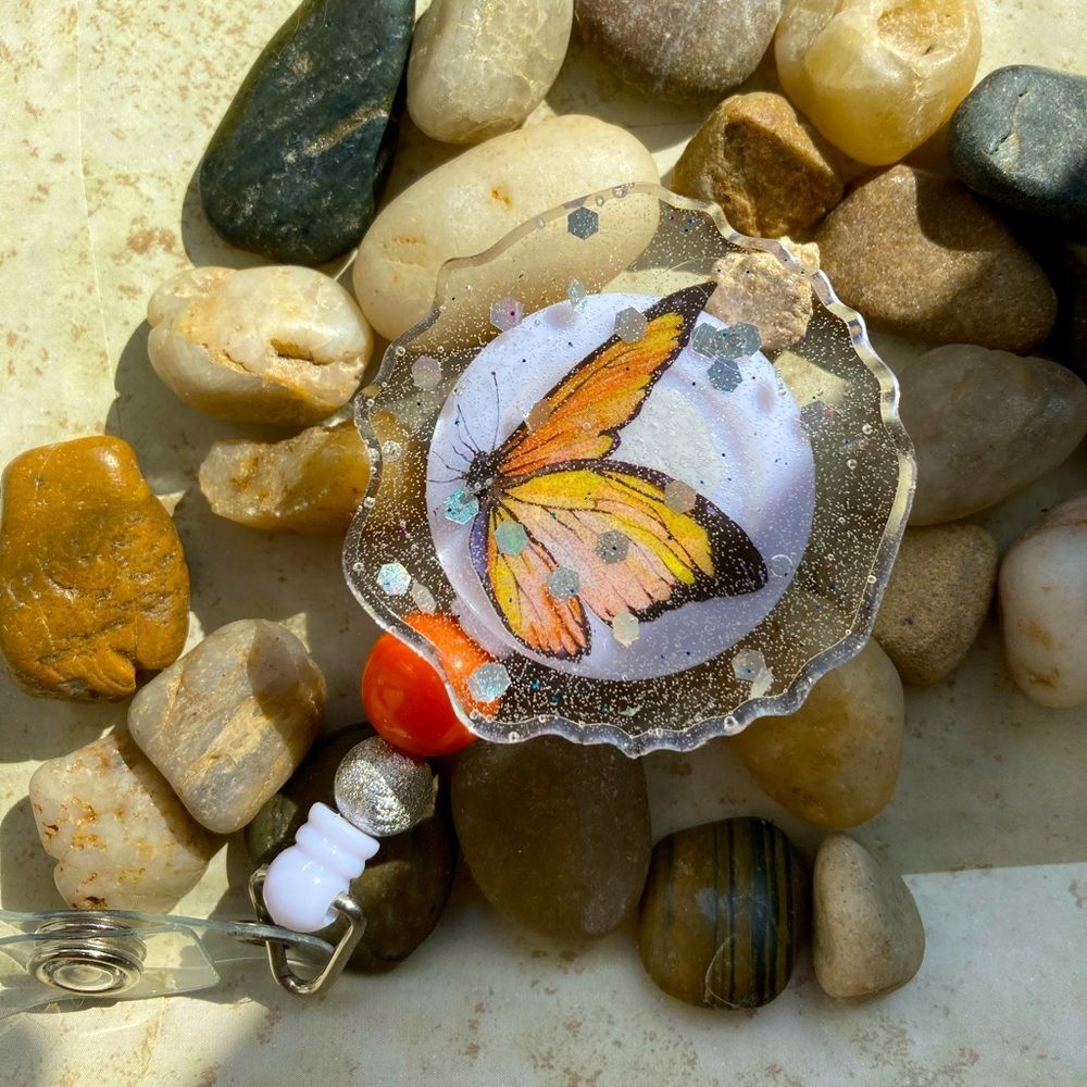 White badge clip w/ orange butterfly